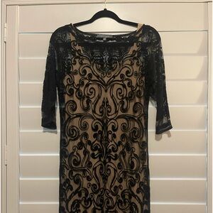 Gorgeous embroidered overlay with a nude knit slip.